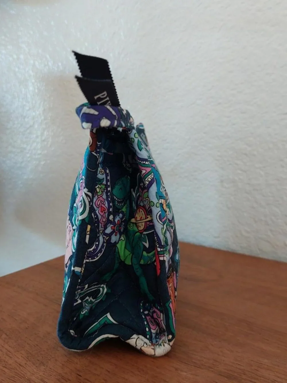 vera bradley Disney Toy Story quilted pouch with characters in a paisley design
